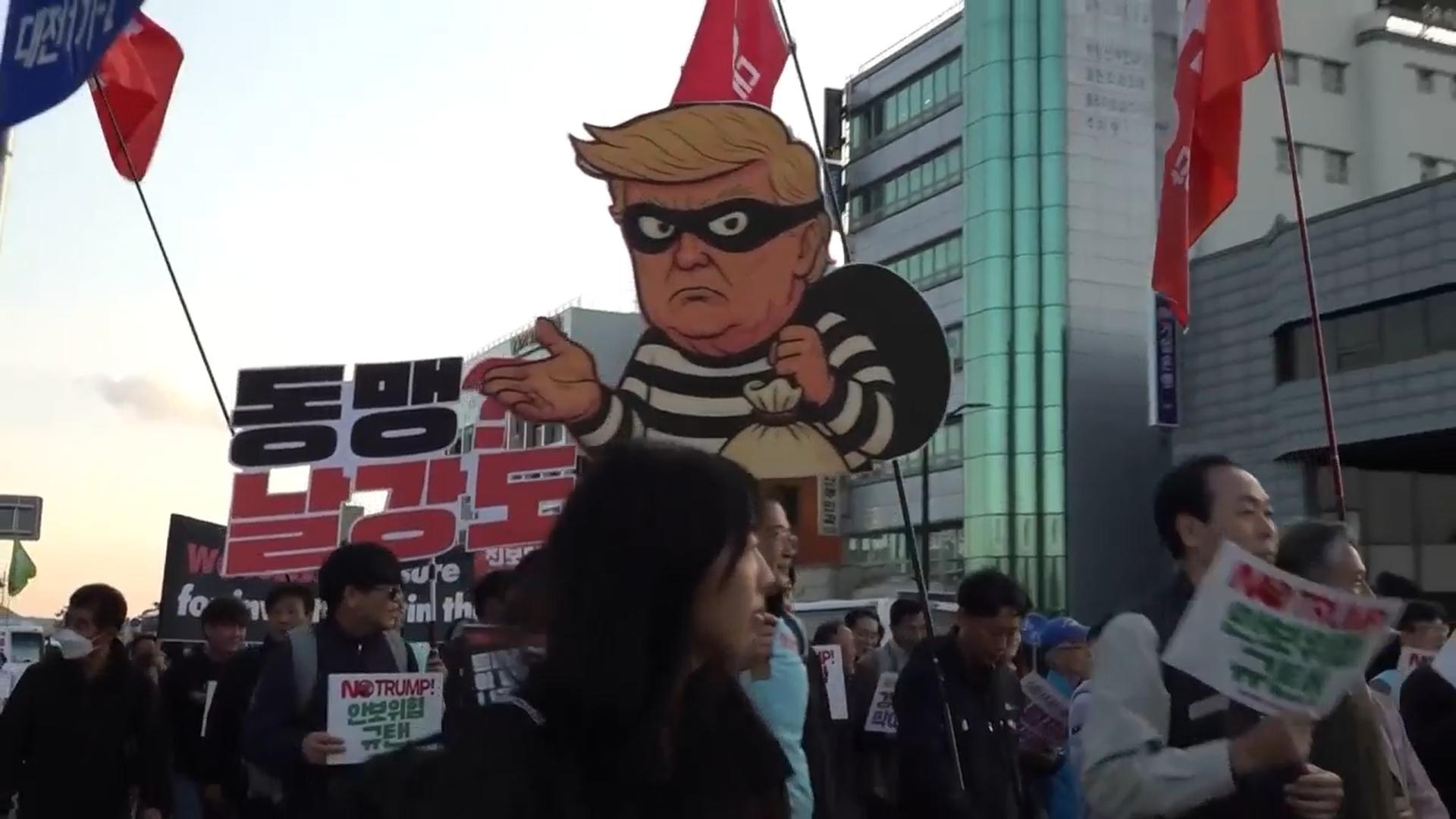 Protests erupt outside APEC summit over Trump's financial demands