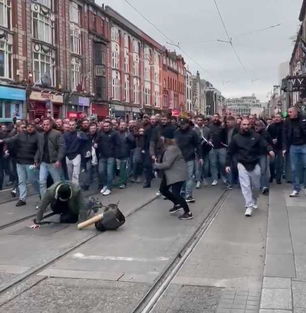 Shocking moment football hooligans attack female photographer and man in his 70s