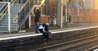 Youths help woman get phone back from railway track