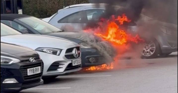 Terrifying moment car bursts into flames in supermarket car park