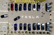 Parents of college student killed in Tesla crash say design flaw in door trapped her as car burned