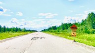 Rather than Actually Fix the Road, One of these Bright Orange Signs Should Do the Trick