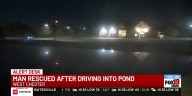 Man rescued after driving into pond