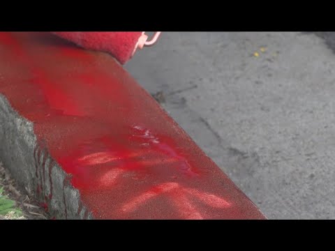 Volunteers use red chalk to mark curbs and raise awareness about daylighting law