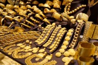 Gold, silver tumble from record highs as festive glow fades amid weak global cues