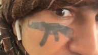 Migrant with AK-47 face tattoo jailed for threatening to kill Nigel Farage
