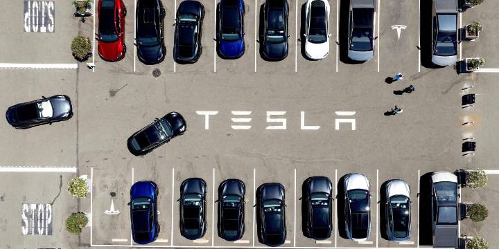 The parents of a college student killed in a Tesla crash say she was trapped in the car as it burst into flames because of a design flaw