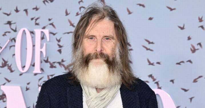 Can you name this British TV icon? Star sports bushy grey beard on red carpet