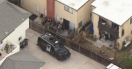 Long Beach police detain person of interest in homicide investigation after standoff in Huntington Beach