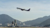 A cargo aircraft skids off a Hong Kong runway into the sea, killing 2 people