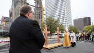 Blessings offered over new crosses to be installed atop repaired spires of Holy Family Cathedral