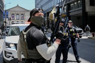 'Bang, bang you're dead, liberal': Video shows federal agent pointing gun at protester