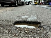 Woman banker killed after falling off bike, run over by truck on pothole
