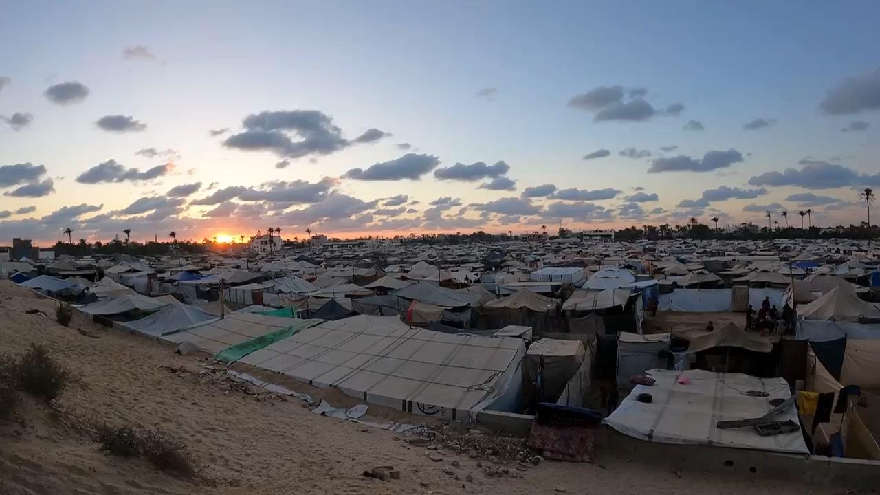 Timelapse from day to night of vast central Gaza tent camp housing displaced Palestinians