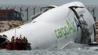 Cargo plane slides off runway in Hong Kong 