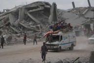 The Latest: Palestinians journey back home as aid convoys start to enter Gaza