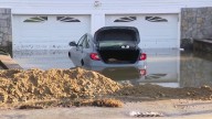Car submurged after water floods driveway