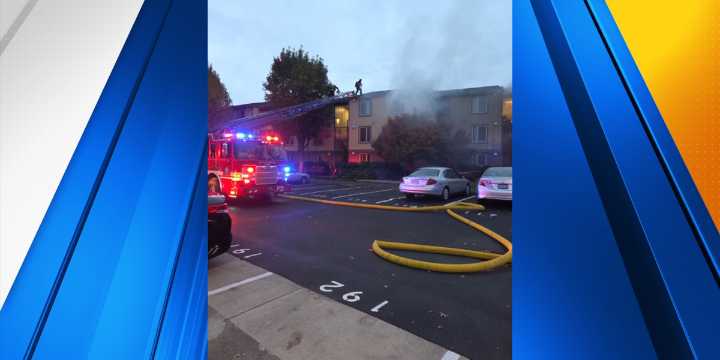 2 people hurt after apartment building catches fire in Happy Valley