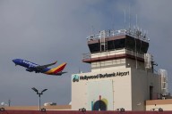 A plane takes off from Hollywood Burbank Airport as operations resume a day after the airport operated for hours without a staffed control tower due to staffing shortages amid the U.S. government shut