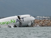 Cargo plane skids off Hong Kong runway into sea