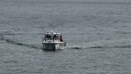 Police, lifesavers and coast guard searching for man in his 20s missing after boat capsize near Mornington Pier, Victoria