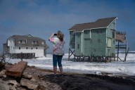 Dozens rescued as remnants of typhoon hits Alaska while nor’easter brings flooding to East Coast