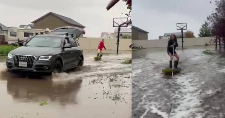 Family embraces flooding from rainstorm by backyard wakesurfing