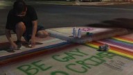 Protestors use chalk, paint to cover sidewalks with rainbows after crosswalk removed in Montrose