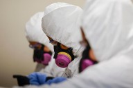 In the fire zones, an immigrant workforce warily carries out cleanups
