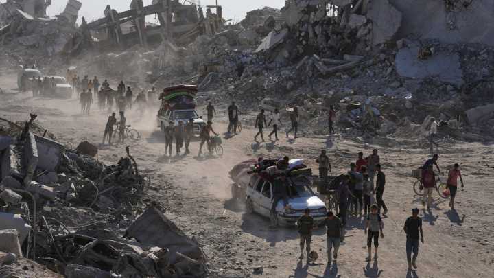Some Palestinians pack up and move north toward their homes in Gaza after ceasefire goes into effect