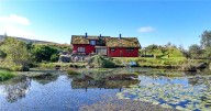 Red Swedish timber house in Scotland with its own lochs for sale