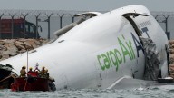 Dubai cargo plane skids off Hong Kong airport runway into sea, two dead