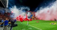 Israeli soccer game abandoned after rioting rival fans throw flares and smoke grenades