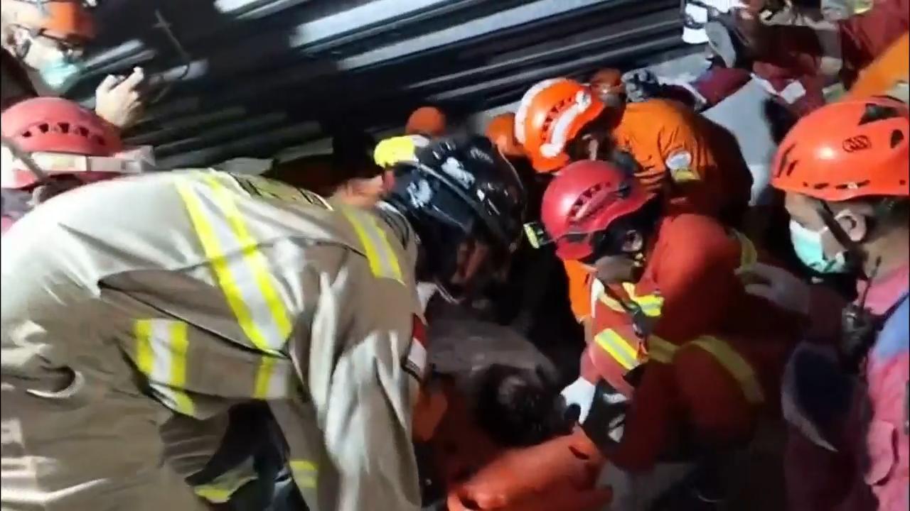 Rescuers chip away debris with hand tools to save those trapped in Indonesia school collapse
