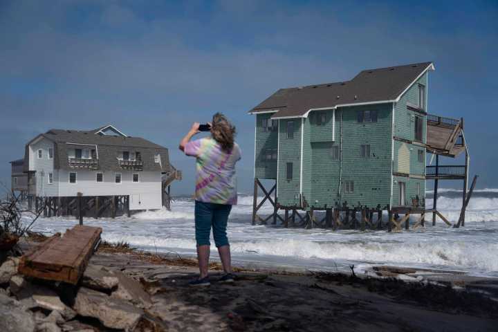 Dozens rescued as remnants of typhoon hits Alaska while nor’easter brings flooding to East Coast