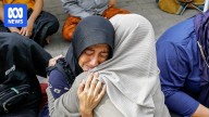 Rescuers pull children from the rubble of Indonesian boarding school collapse
