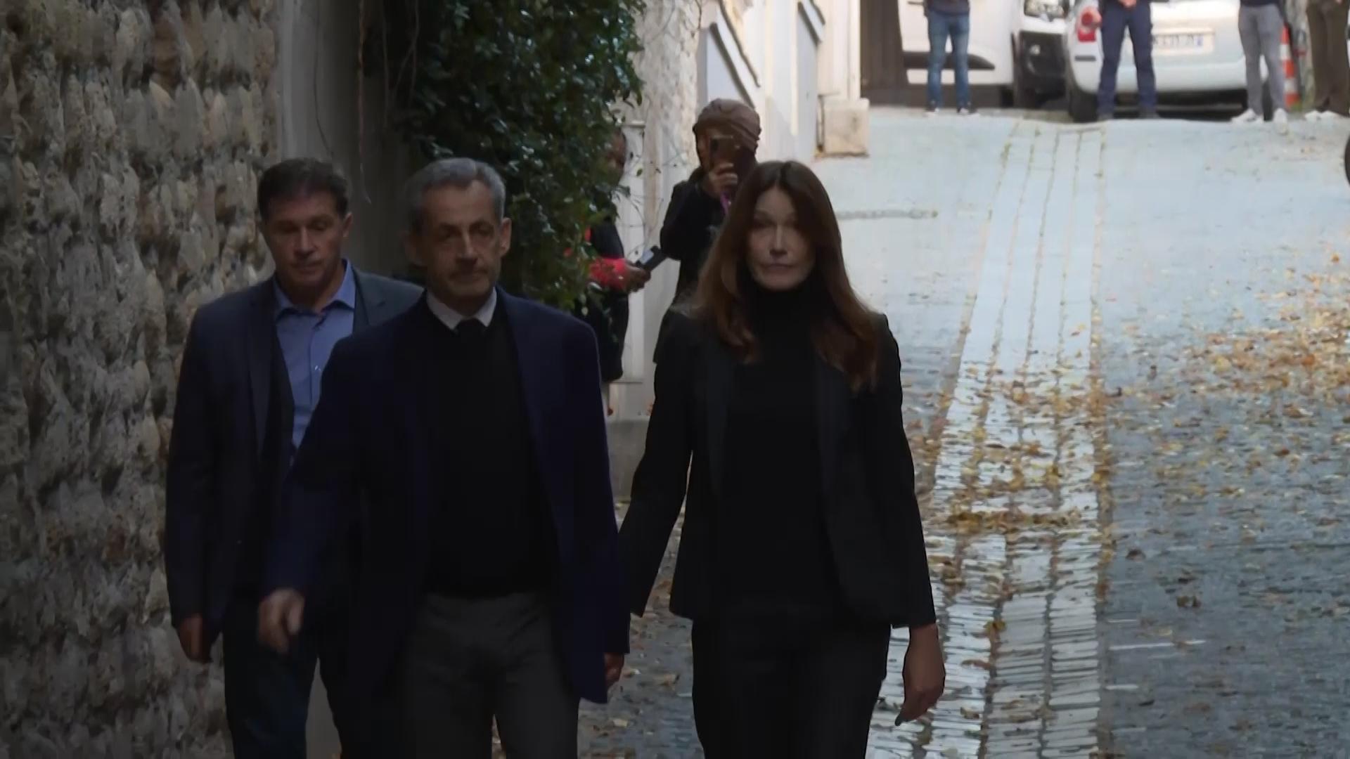Former French president Nicolas Sarkozy greets supporters, hugs wife before heading to prison