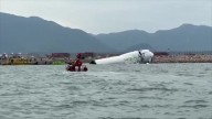 A cargo aircraft skids off a Hong Kong runway into the sea, killing 2 airport workers