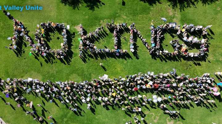 Attendees spell out 'No Kings In The USA' at Chandler protest