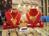 Gold likely to stay high as weak rupee and global demand lift prices: Report