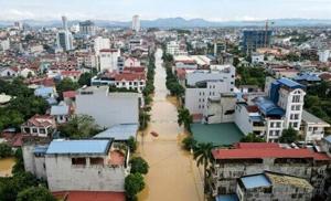 Record flooding hits Vietnam city, eight killed in north