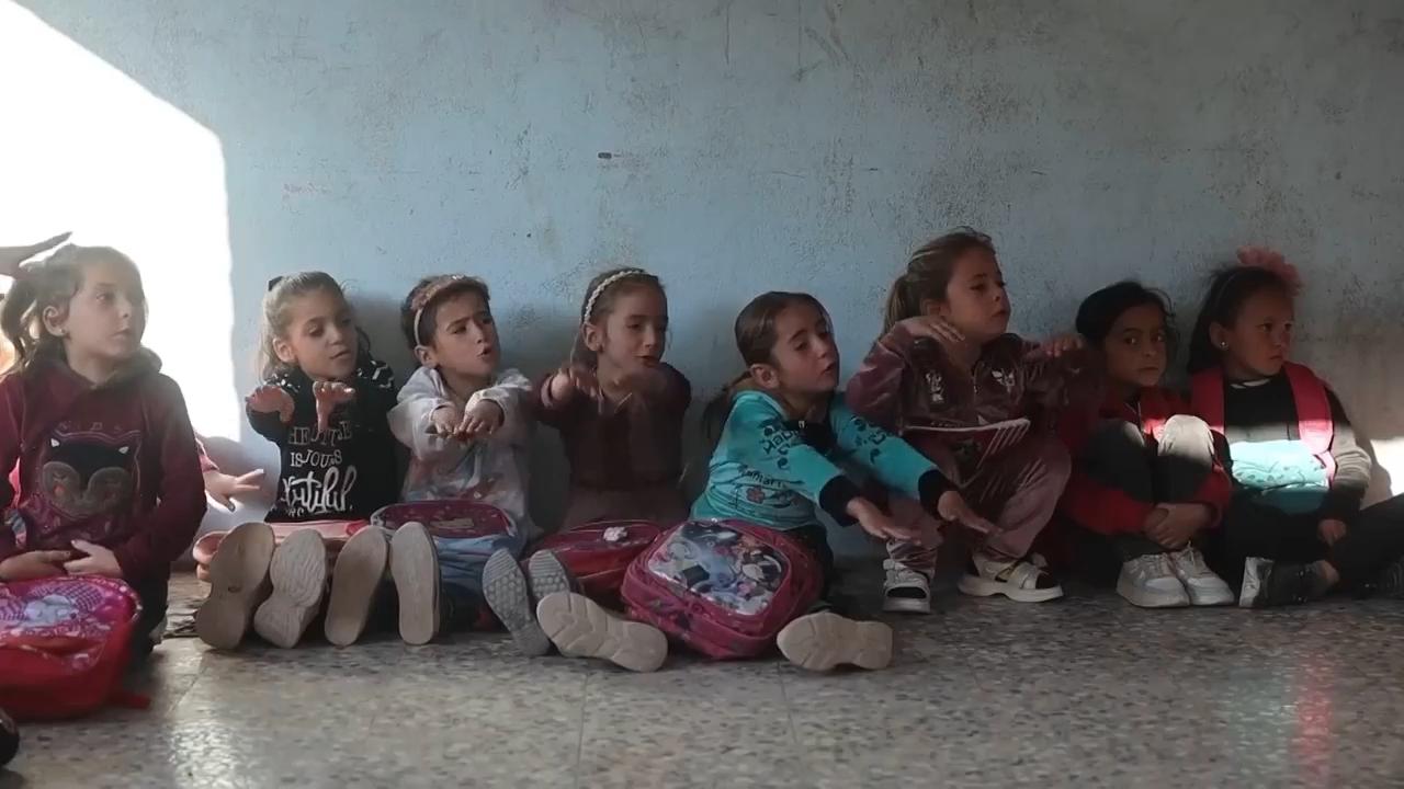 Syrian students return to schools stripped bare by conflict