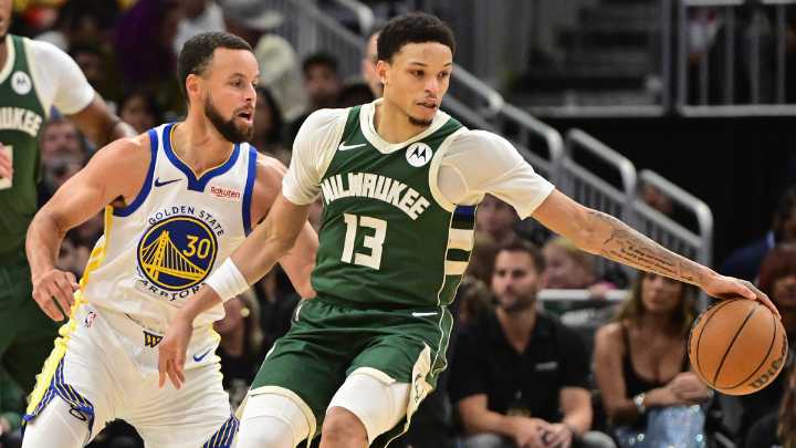 Ryan Rollins reacts to Steph Curry signing his jersey for him