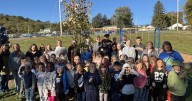 Kindergarteners help plant trees at Hedgesville Elementary School
