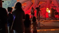 Night Glow illuminates the night sky behind Arts in The Sunset