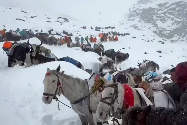 Snowstorms strand hikers in China and a South Korean climber dies in Nepal