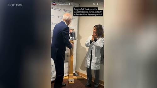 Former President Joe Biden rings the bell after completing course of radiation therapy for cancer at Penn Medicine in Philadelphia