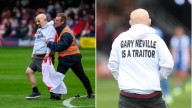 Pitch invader at Salford City match parades England flag to protest against Gary Neville