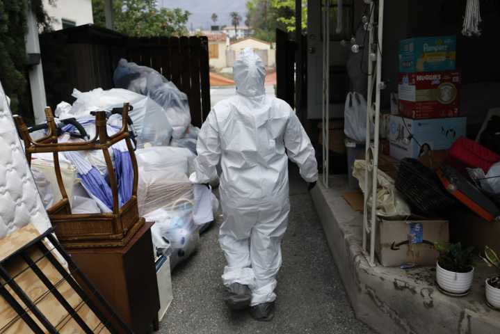 In the fire zones, an immigrant workforce warily carries out cleanups