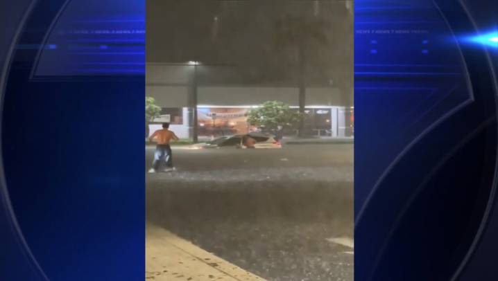 Overnight downpours flood roads in parts of Broward, Palm Beach; good Samaritans rescue elderly man trapped in car 